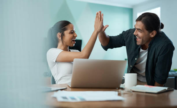 istock Shot of a young couple doing paperwork while using a laptop at home 1329523067