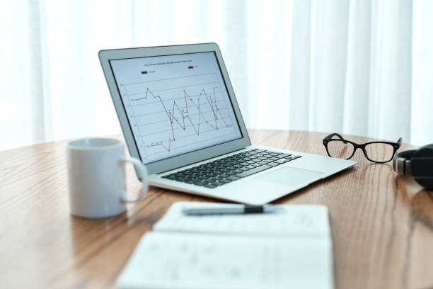 Empty shot of a laptop and notebook on a table at home