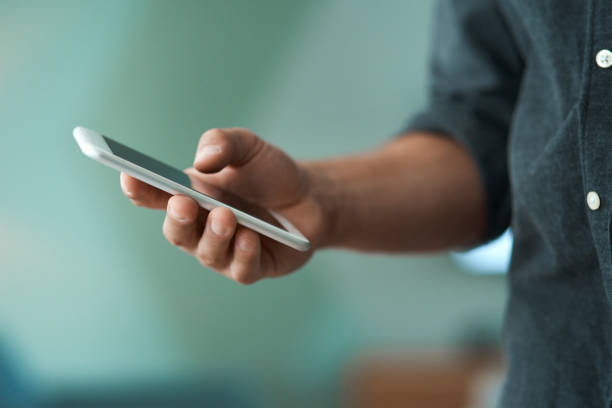 istock Shot of an unrecognizable man using a smartphone 1329523185