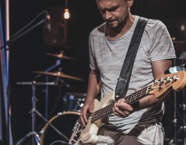 istock Musician with bass guitar during a performance. 1329524356