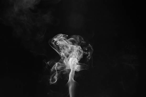 istock abstract fragment movement of white smoke on black background. 1329524477