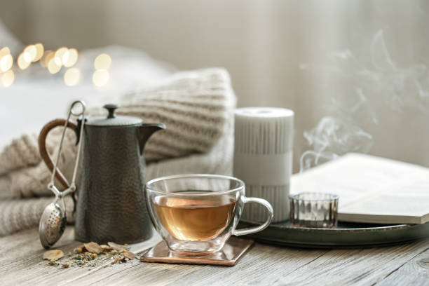 istock Cozy composition with a cup of tea and a teapot on a blurred background. 1329524554