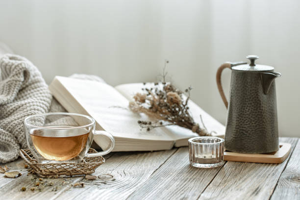istock Home still life with a cup of tea, a teapot and a book. 1329524556