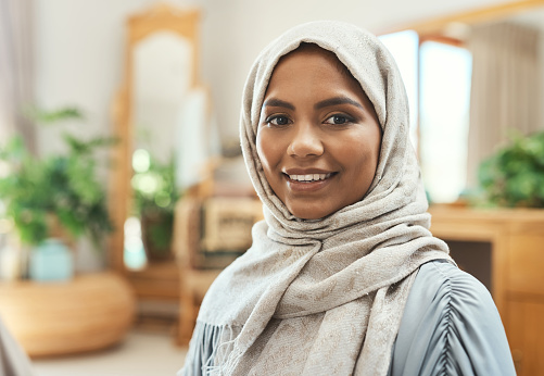 Shot of a young muslim woman sitting in the loung at home