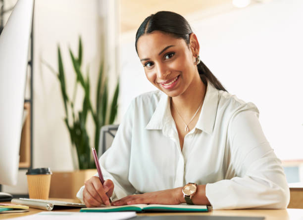 istock Shot of a young businesswoman compiling notes at work 1329525925