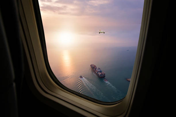 istock Aerial view of cargo ship in transit. View from airplane window. 1329526253
