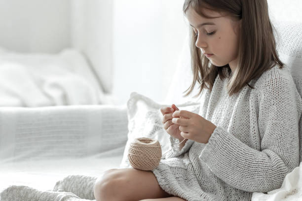 istock Little girl learning to knit, home leisure and needlework concept. 1329526286