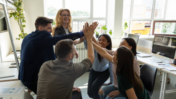 istock Happy excited diverse team, mixed race office employees 1329526345