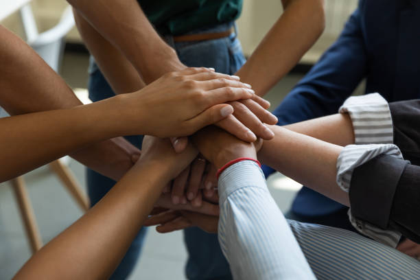 istock Business team stack of hands. Employees joining hands together 1329526354