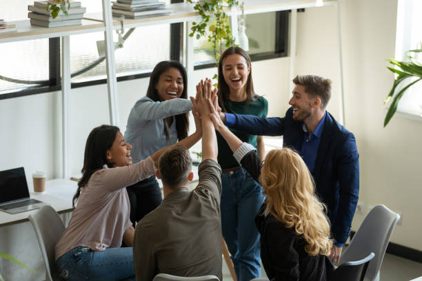istock Happy overjoyed mixed race millennial team celebrating success 1329526355