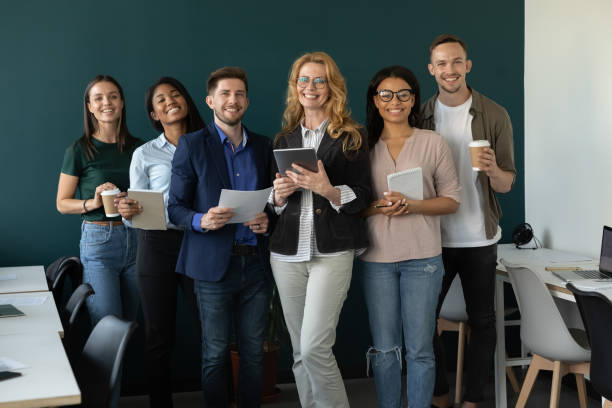 istock Happy diverse business team, staff, employees smiling at camera 1329526362