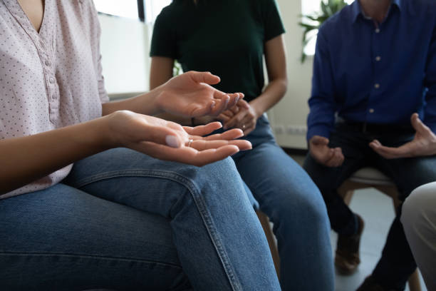 istock Team of anonymous addicted community meeting for group therapy 1329526389
