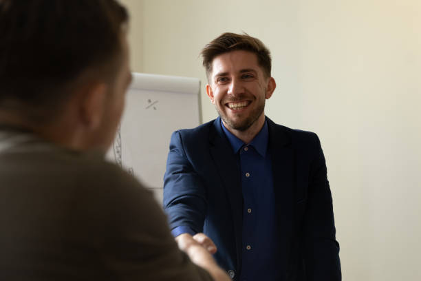istock Businessman, client, customer giving handshake to lawyer, thanking for help 1329526396