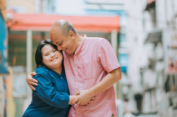 happy asian malay autism down syndrome female  bonding  with her father in city street happy asian malay autism down syndrome female  bonding  with her father in city street developmental disability stock pictures, royalty-free photos & images