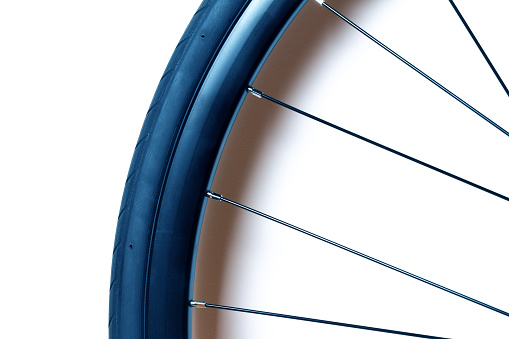 New road bike wheel with tire and spokes isolated on white background