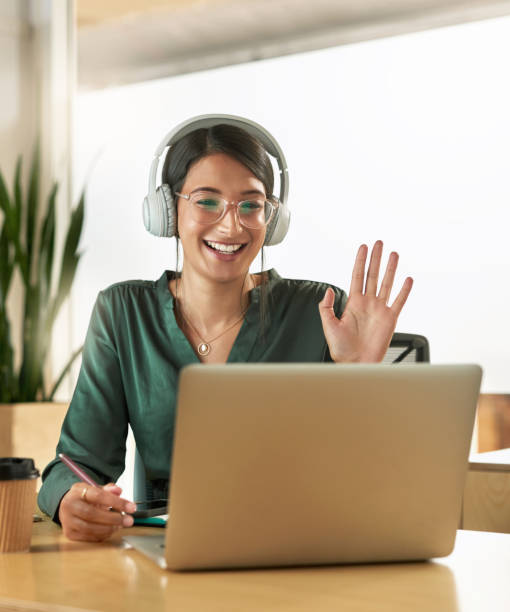 Shot of a young businesswoman using her laptop to host a video conference at work Hi thank you for joining me video conference stock pictures, royalty-free photos & images
