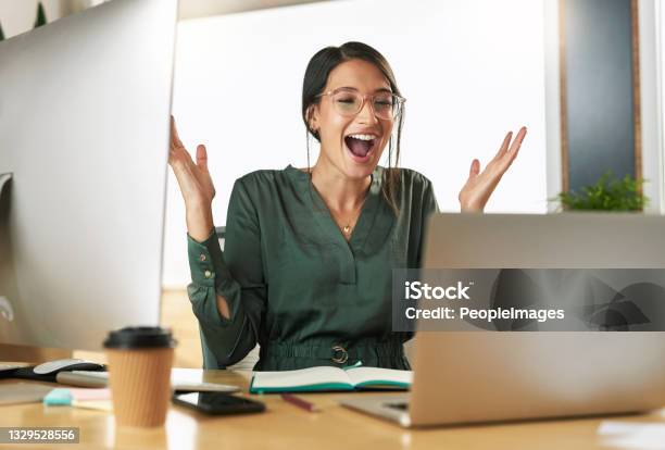 Shot Of A Young Businesswoman Cheering During A Video Conference At Work Stock Photo - Download Image Now