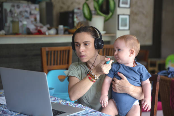 istock Multi-Tasking Mom Working And Feeding Baby at The Same Time 1329529905
