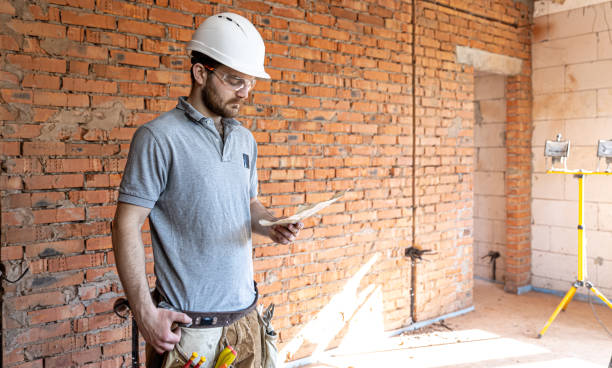 istock An electrician contractor examines a blueprint at a construction site. 1329531060