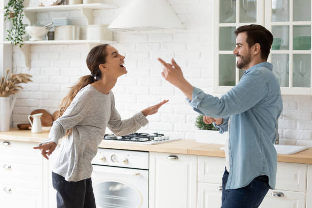 istock Excited active couple listen music sing dance together in kitchen 1329531275