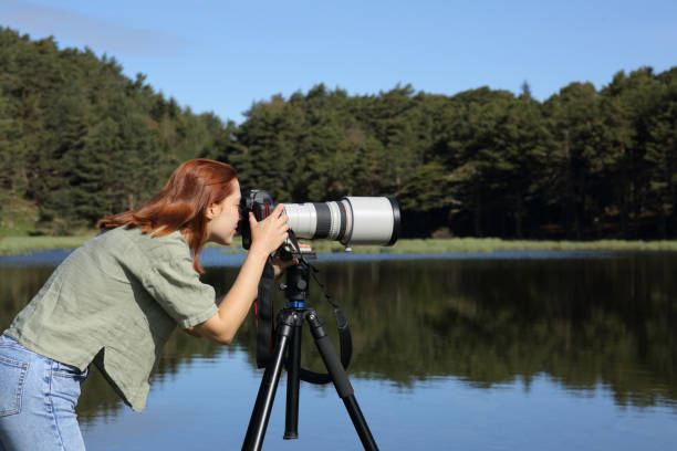 Photographer taking photo with telephoto and dslr camera Photographer taking photo with telephoto and dslr camera telephoto lens stock pictures, royalty-free photos & images