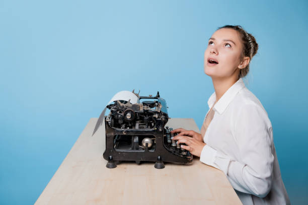 istock young woman writer at a typewriter, is inspired, is passionate about writing a text. 1329539516