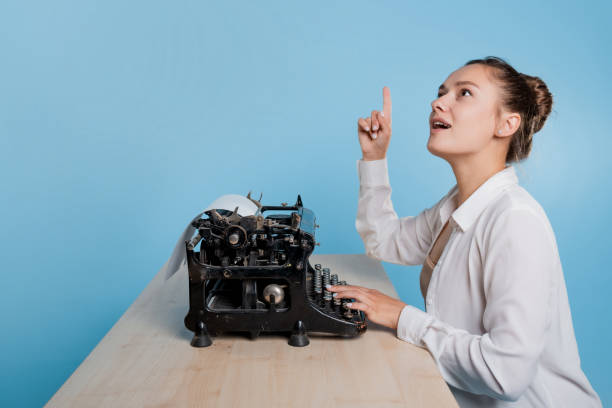 istock young woman writer at a typewriter, is inspired, is passionate about writing a text. 1329539549