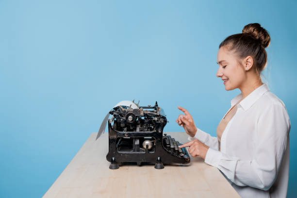 istock young woman writer at a typewriter, is inspired, is passionate about writing a text. 1329539562