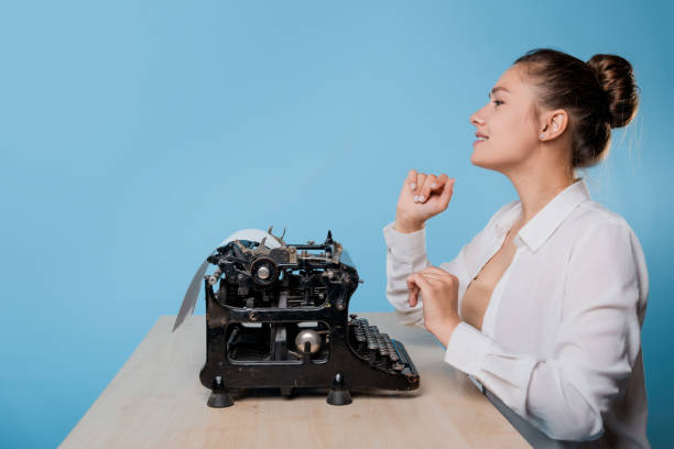 istock young woman writer at a typewriter, is inspired, is passionate about writing a text. 1329539593