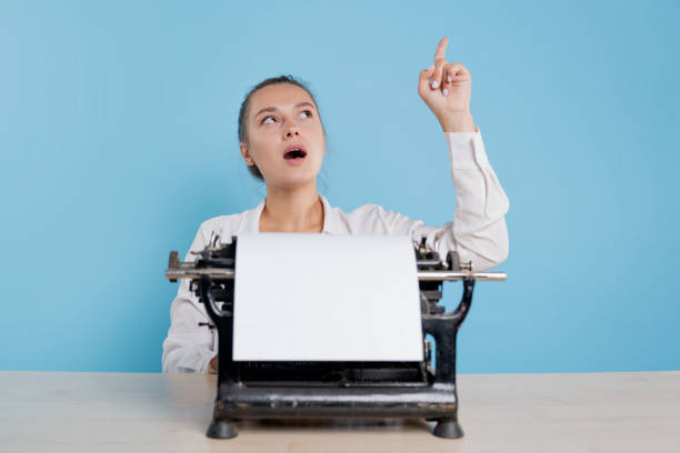 istock An author at a typewriter, a young female blogger or writer 1329539614