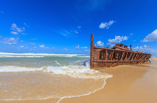 Picture of a rusted shipwreck at Seventy Five Mile Beach on Frazer Island in Australia during daytime