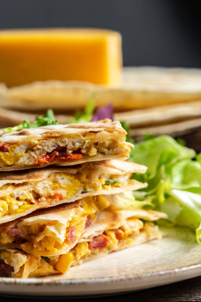 istock Traditional Mexican tortillas with quesadilla with scramble eggs, vegetables, ham and cheese. Mexican cuisine, Mexico and Latin America traditional restaurant menu dish 1329543183