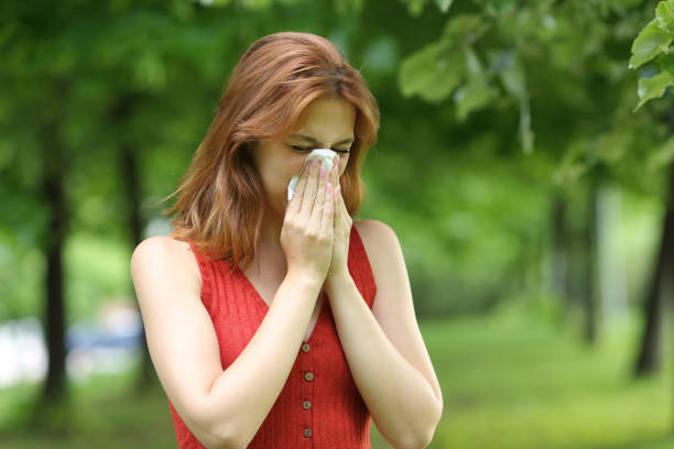 istock Ill woman blowing on cloth in a park 1329543590