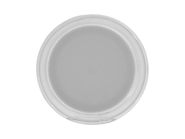 Plastic transparent jar, closed with a lid. Isolated on a white background, close - up view from above