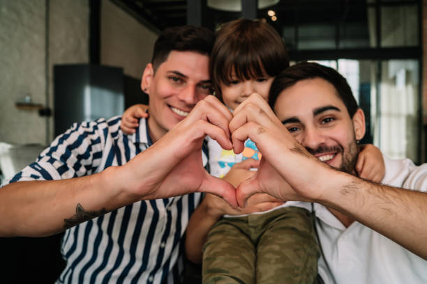 istock Happy gay couple with their son. 1329546181