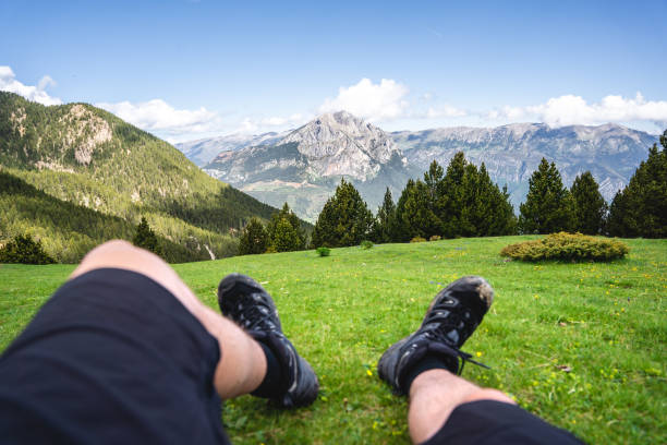 istock Boy lying in the grass with a gorgeous mountain range in the horizon 1329546279