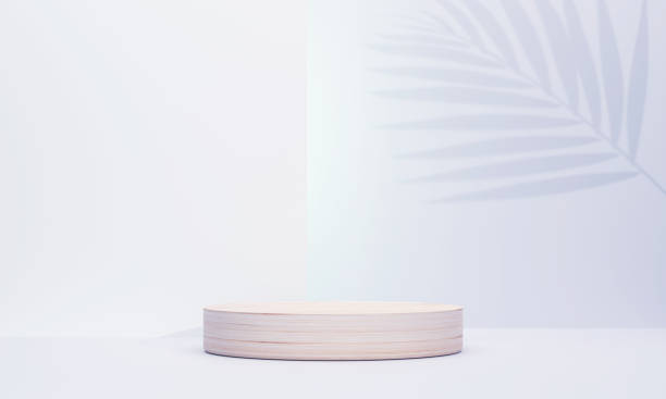 istock Large circular wooden podium on a background with palm leaf shadows behind in a relaxed feeling. scene stage mockup showcase for product, sale, banner, presentation, cosmetic, offer. 1329547343