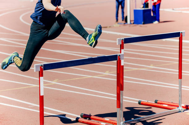 girl athlete run hurdles