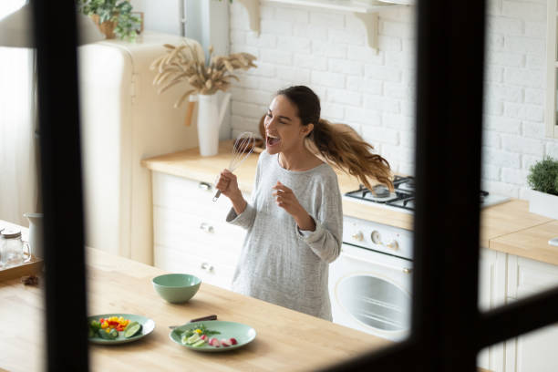 istock Young mixed race woman singing using beater like microphone 1329553191