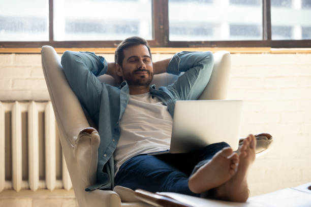 istock Serene man accomplish work on laptop relaxing on leather armchair 1329553236
