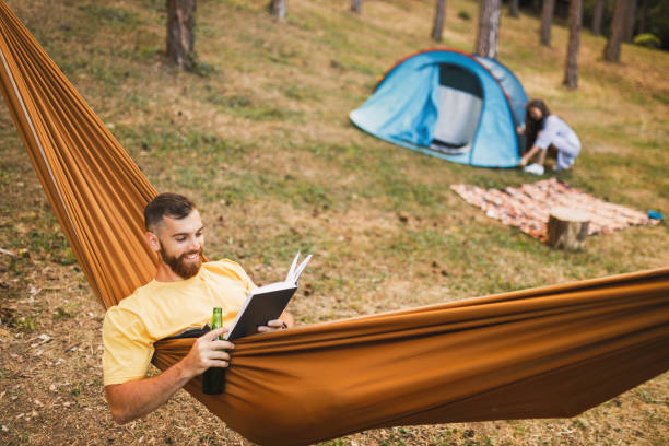 istock Young couple enjoying in camping in forest 1329554932
