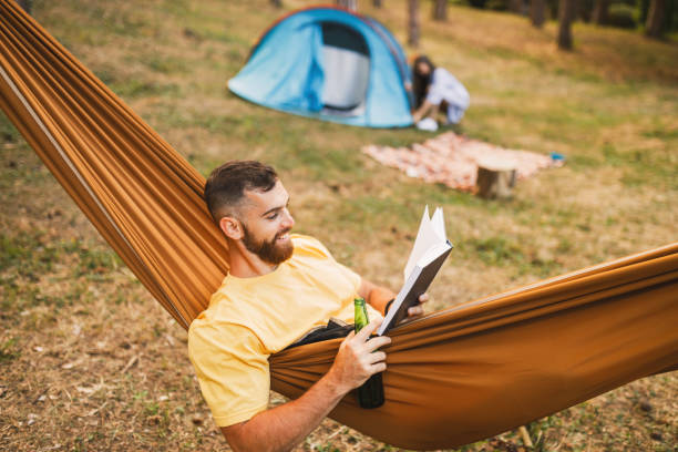 istock Young couple enjoying in camping in forest 1329555008