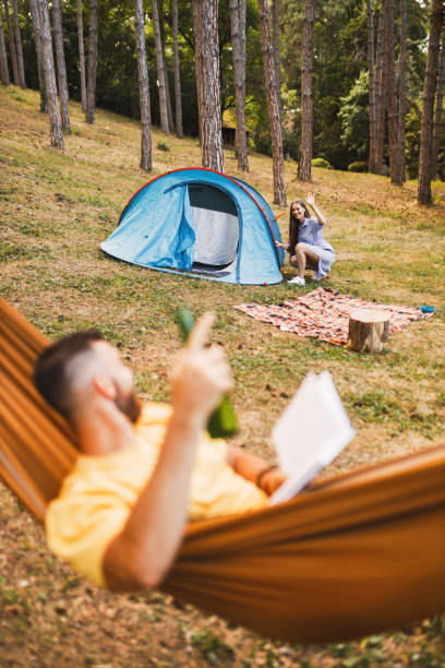 istock Young couple enjoying in camping in forest 1329555179