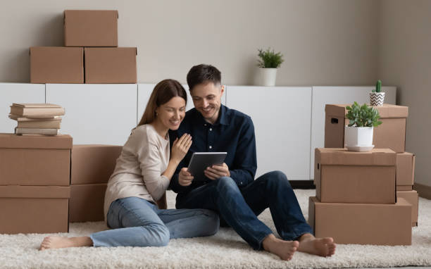 istock Happy couple renters use gadget search home for rent 1329558109
