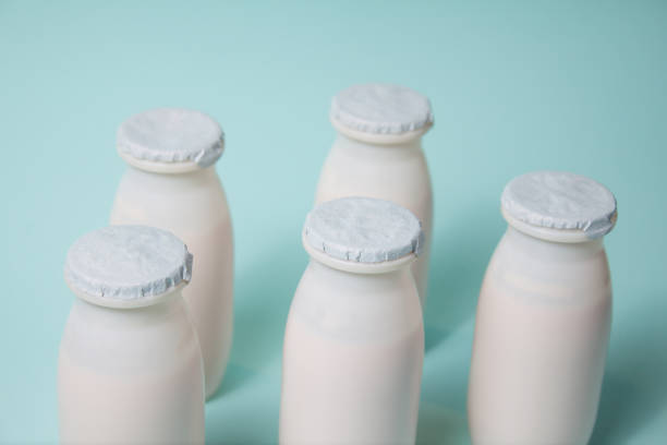 istock Bottles with probiotics and prebiotics dairy drink on light blue background. 1329560273