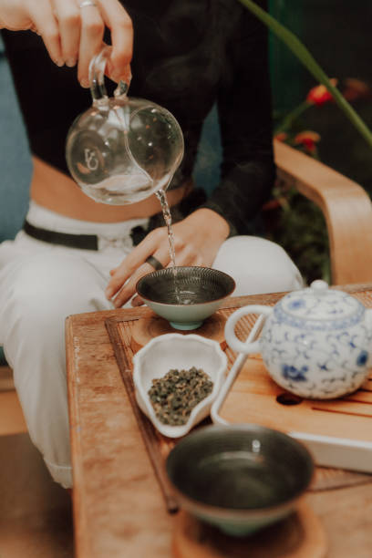 istock Woman serving Chinese tea in a tea ceremony 1329560292