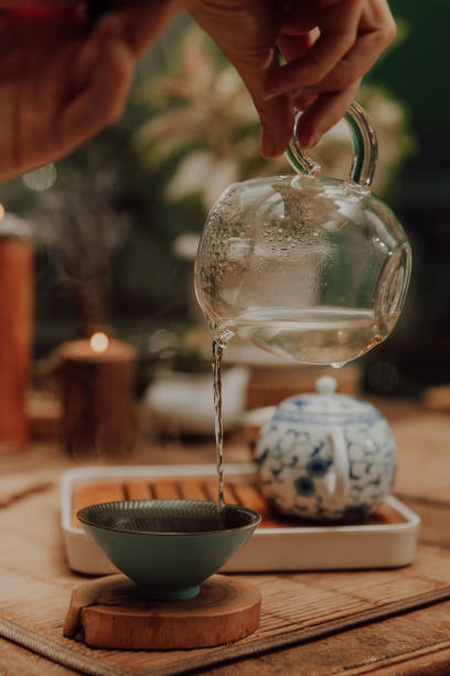 istock Woman serving Chinese tea in a tea ceremony 1329561370