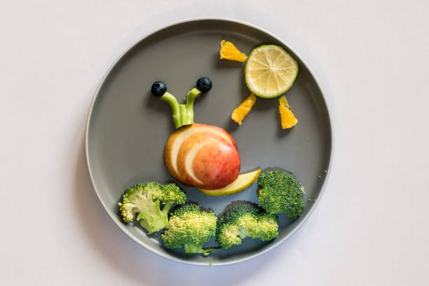 istock healthy breakfast for children, creative ideas from fruit and vegetables, vitamins on plate, 1329561492