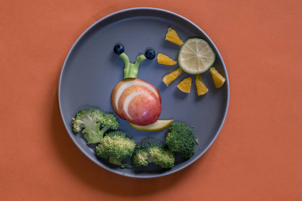 istock healthy breakfast for children, creative ideas from fruit and vegetables, vitamins on plate, 1329561498