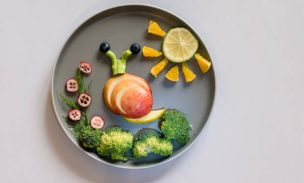 istock healthy breakfast for children, creative ideas from fruit and vegetables, vitamins on plate, 1329562094